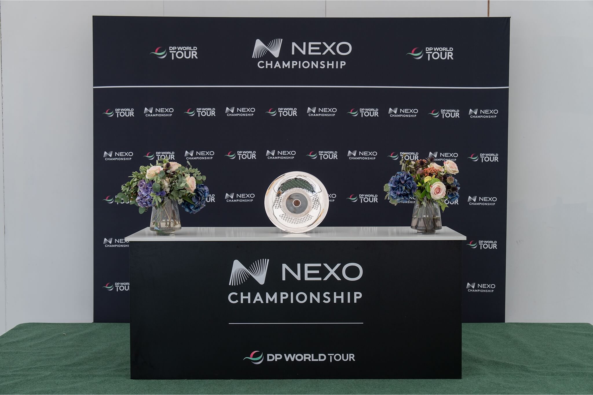 A display table featuring the Nexo Championship trophy.